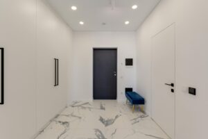 Sleek and contemporary corridor with marble flooring and white walls.
