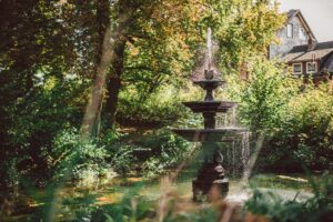 Serene fountain in a vibrant park setting in Einbeck, Germany.