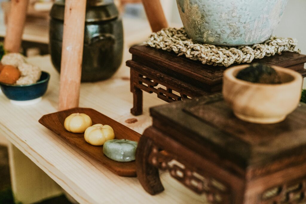 Close-up of rustic wooden decor displaying traditional items, bowls, and trays.