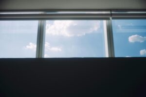 Cloudy sky visible through modern windows, offering a serene and minimalist view.