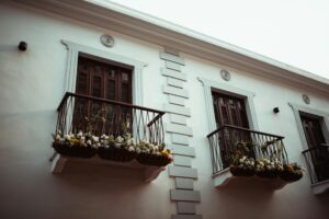 Beautiful balcony adorned with ornamental plants and flowers on a modern building facade.