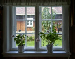 Charming window view with geraniums overlooking a countryside home in Lillehammer.