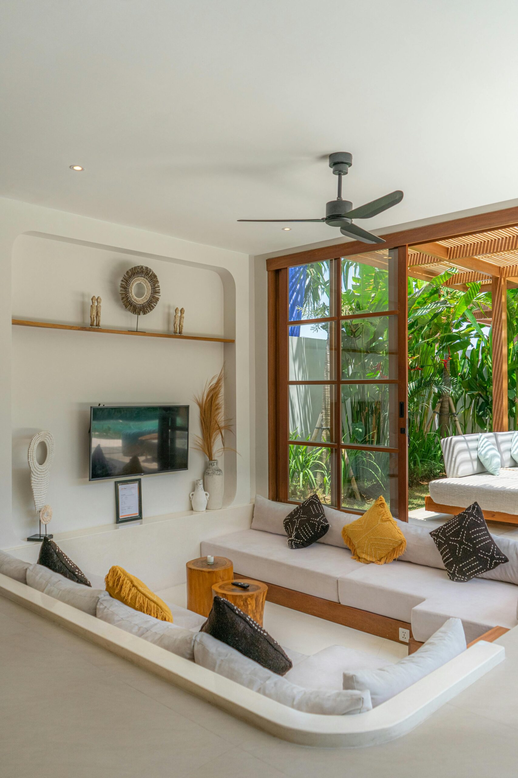 Stylish modern living room with large window overlooking lush garden.