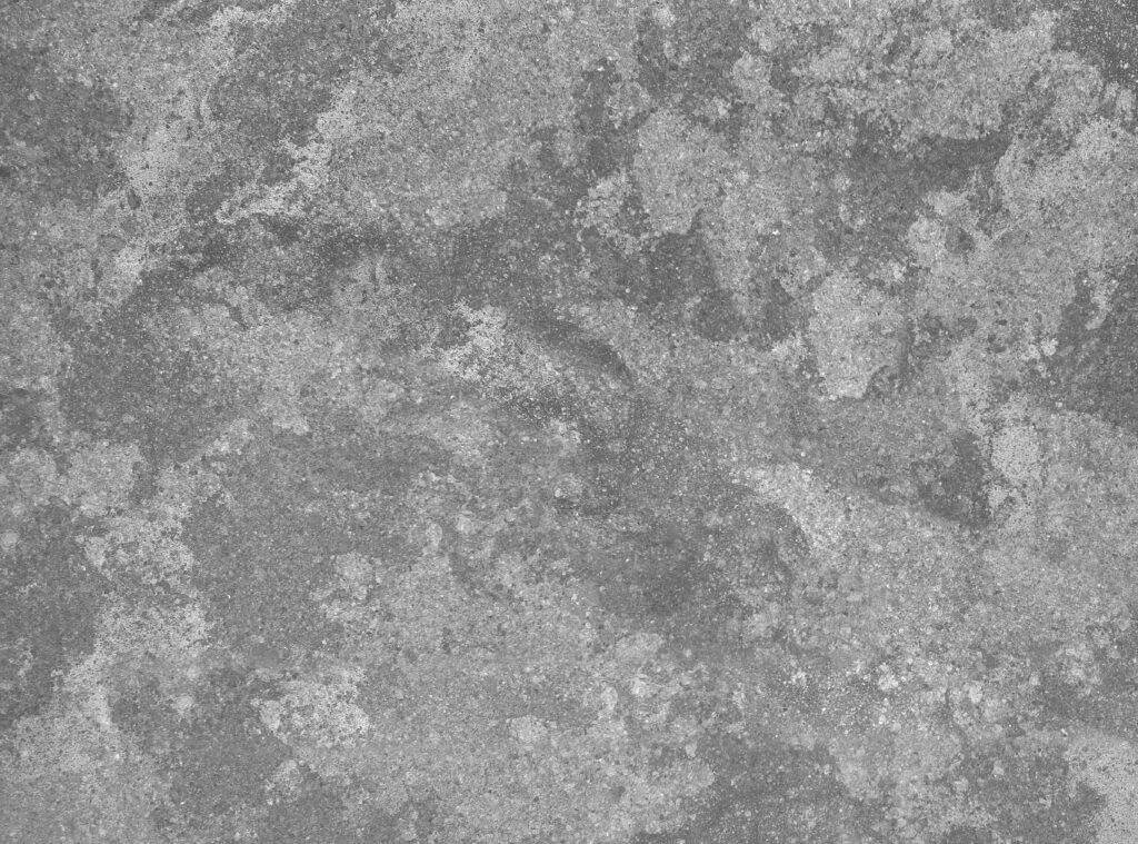 Close-up of a gray cement wall with rough, textured surface ideal for backgrounds.