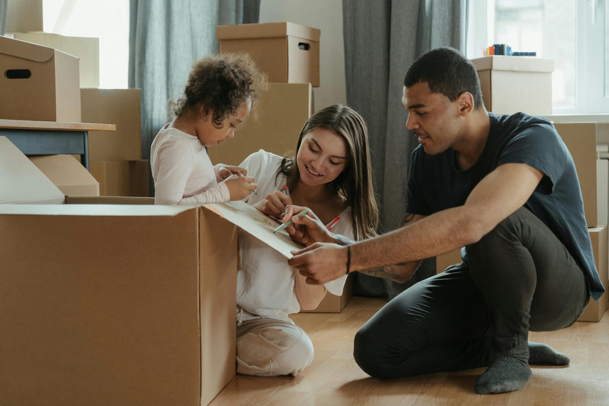 A family involved in a creative activity while moving into their new home.