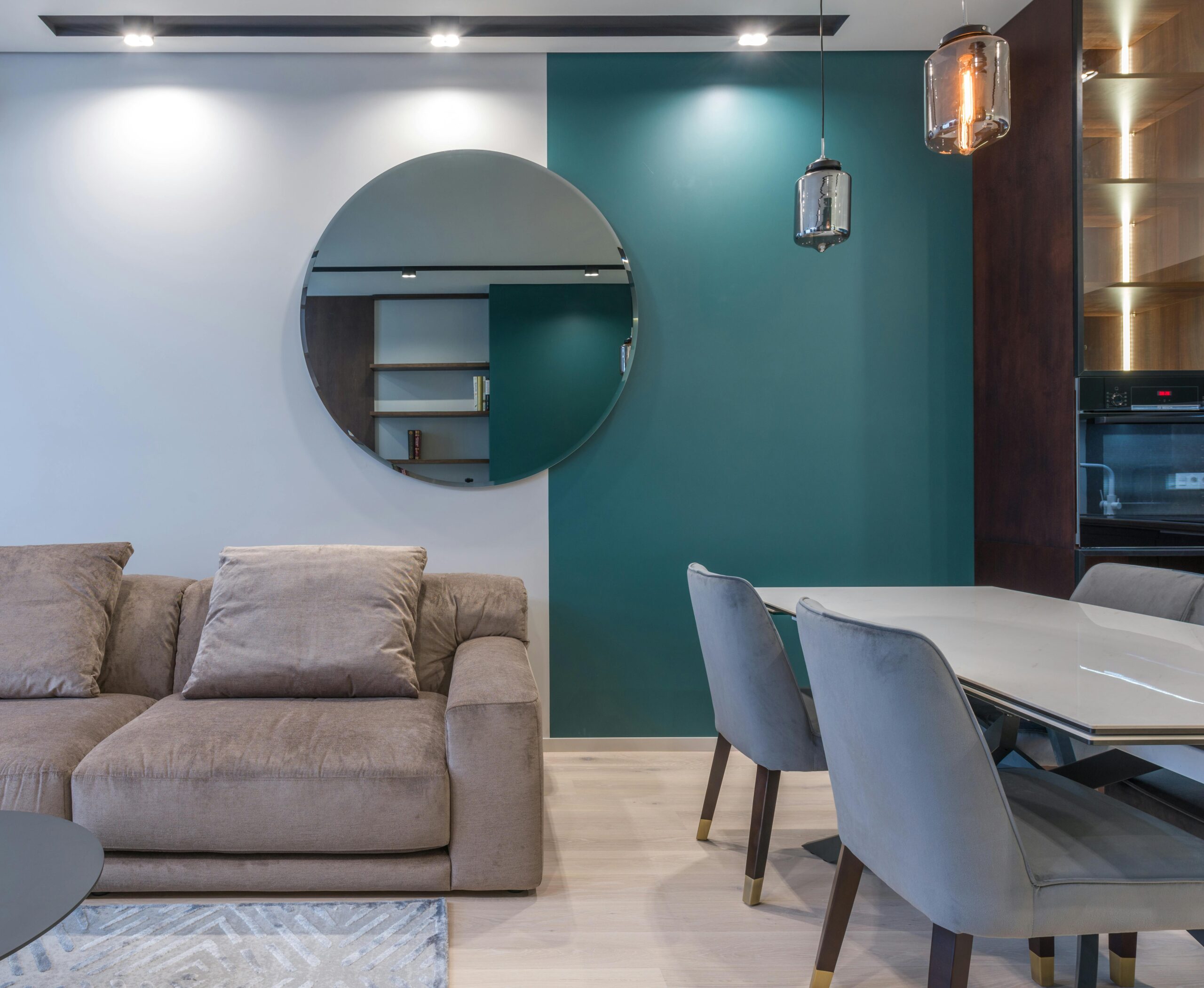 Stylish living room with a modern dining area and accent mirror detail.