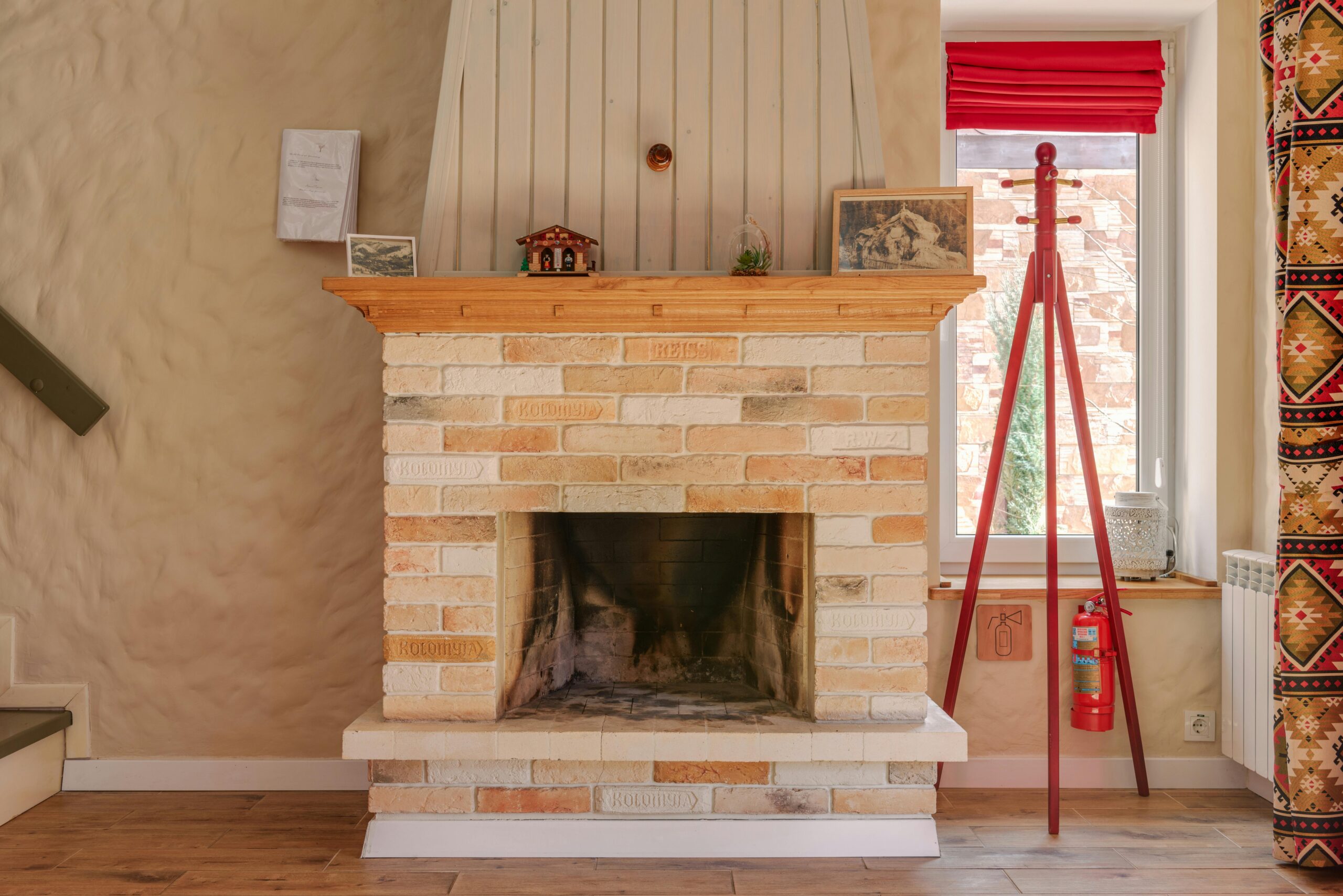 A warm living room with a rustic brick fireplace and stylish decor.