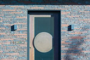 Contemporary brick building facade showcasing a stylish entrance with a geometric door design.